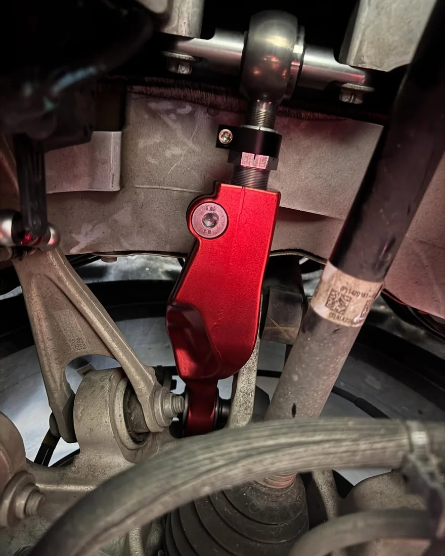N2ITIVE adjustable rear control arm installed in the opposite rear wheel well of a Tesla Model X